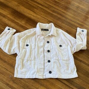 White corduroy jacket with black buttons